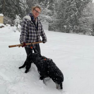 Danelle helping Noah walk in the snow.